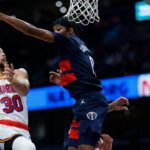 Golden State Warriors guard Stephen Curry (30) shoots the ball as Washington Wizards guard Bilal Coulibaly (0) defends in the second half at Capital One Arena