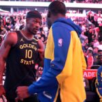 Golden State Warriors forward Jimmy Butler (10) talks with new teammate Draymond Green before taking on the Chicago Bulls at the United Center