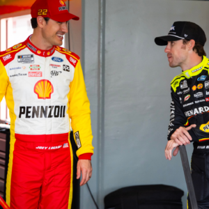 Feb 12, 2025; Daytona Beach, Florida, USA; NASCAR Cup Series driver Joey Logano (left) talks with teammate Ryan Blaney during practice for the Daytona 500 at Daytona International Speedway. Mandatory Credit: Mark J. Rebilas-Imagn Images