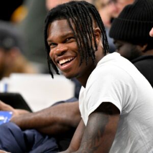Jan 22, 2025; Dallas, Texas, USA; 2024 Heisman Trophy winner Travis Hunter Jr. laughs during the second half of the game between the Dallas Mavericks and the Minnesota Timberwolves at the American Airlines Center.
