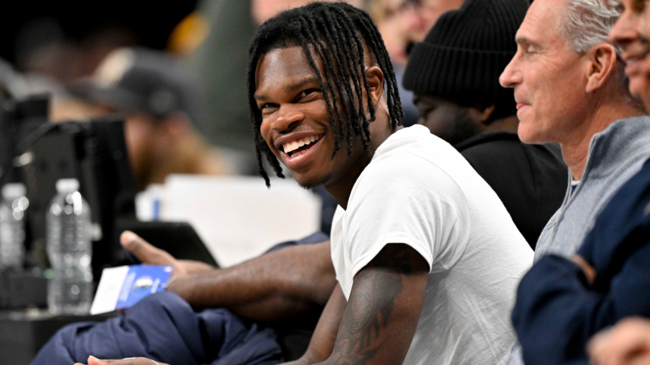 Jan 22, 2025; Dallas, Texas, USA; 2024 Heisman Trophy winner Travis Hunter Jr. laughs during the second half of the game between the Dallas Mavericks and the Minnesota Timberwolves at the American Airlines Center.