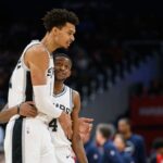San Antonio Spurs center Victor Wembanyama (1) and guard De'Aaron Fox (4) react during the second quarter against the Washington Wizards at Capital One Arena