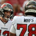 Tampa Bay Buccaneers quarterback Tom Brady (12) huddles up with offensive tackle Tristan Wirfs (78) against the Carolina Panthers prior to the game at Raymond James Stadium.