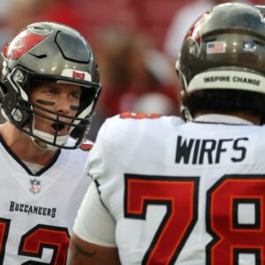 Tampa Bay Buccaneers quarterback Tom Brady (12) huddles up with offensive tackle Tristan Wirfs (78) against the Carolina Panthers prior to the game at Raymond James Stadium.