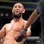 Khamzat Chimaev (red gloves) fights Kevin Holland (blue gloves) during UFC 279 at T-Mobile Arena.
