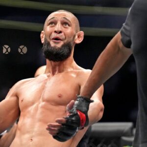Khamzat Chimaev (red gloves) fights Kevin Holland (blue gloves) during UFC 279 at T-Mobile Arena.