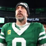 Jan 5, 2025; East Rutherford, New Jersey, USA; New York Jets quarterback Aaron Rodgers (8) walks on the field after the Jets win over the Miami Dolphins at MetLife Stadium.
