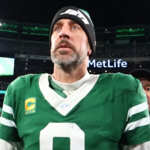 Jan 5, 2025; East Rutherford, New Jersey, USA; New York Jets quarterback Aaron Rodgers (8) walks on the field after the Jets win over the Miami Dolphins at MetLife Stadium.