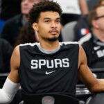 San Antonio Spurs center Victor Wembanyama (1) rests before a game against the Milwaukee Bucks at Frost Bank Center.