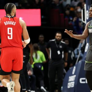 Minnesota Timberwolves guard Anthony Edwards (5) celebrates his three-point basket towards Houston Rockets forward Dillon Brooks (9) during the fourth quarter at Target Center.