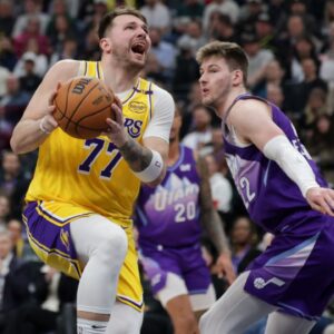 Los Angeles Lakers guard Luka Doncic (77) is fouled by Utah Jazz forward Kyle Filipowski (22) during the second quarter at Delta Center.
