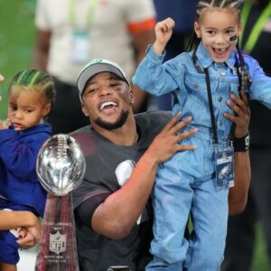 Philadelphia Eagles running back Saquon Barkley (26) talks to the media with his daughter, Jada, after defeating the Kansas City Chiefs in Super Bowl LIX at Caesars Superdome.