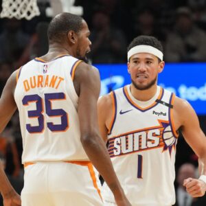 Phoenix Suns forward Kevin Durant (35) and Phoenix Suns guard Devin Booker (1) celebrate against the LA Clippers during the second half at Footprint Center
