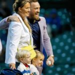 MMA fighter Conor McGregor poses for a photo with his fiance Dee Devlin, his son Conor Jack Jr., and daughter Croia after throwing out a first pitch before the game between the Chicago Cubs and the Minnesota Twins at Wrigley Field.