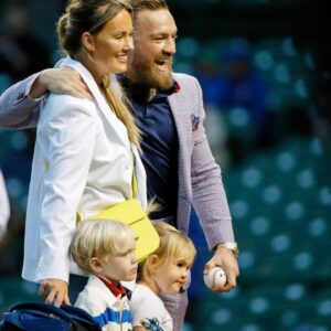 MMA fighter Conor McGregor poses for a photo with his fiance Dee Devlin, his son Conor Jack Jr., and daughter Croia after throwing out a first pitch before the game between the Chicago Cubs and the Minnesota Twins at Wrigley Field.