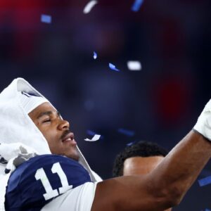 Penn State Nittany Lions defensive end Abdul Carter (11) reacts with the trophy after the game against the Boise State Broncos in the Fiesta Bowl at State Farm Stadium.
