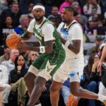 Milwaukee Bucks forward Bobby Portis (9) dribbles against the Minnesota Timberwolves center Naz Reid (11) in the second quarter at Target Center