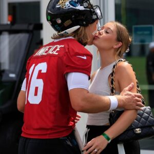 Jacksonville Jaguars quarterback Trevor Lawrence (16) kisses his wife Marissa Lawrence after a combined NFL football training camp session between the Tampa Bay Buccaneers and Jacksonville Jaguars Thursday, Aug. 15, 2024 at EverBank Stadium’s Miller Electric Center in Jacksonville, Fla.