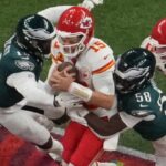 Feb 9, 2025; New Orleans, LA, USA; Kansas City Chiefs quarterback Patrick Mahomes (15) is pressured by Philadelphia Eagles linebacker Josh Sweat (19) and Philadelphia Eagles linebacker Jalyx Hunt (58) in the second quarter during Super Bowl LIX at Caesars Superdome.