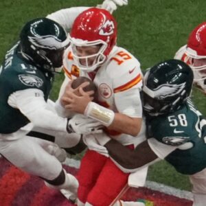Feb 9, 2025; New Orleans, LA, USA; Kansas City Chiefs quarterback Patrick Mahomes (15) is pressured by Philadelphia Eagles linebacker Josh Sweat (19) and Philadelphia Eagles linebacker Jalyx Hunt (58) in the second quarter during Super Bowl LIX at Caesars Superdome.