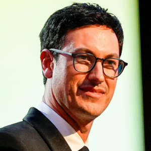 Nov 22, 2024; Charlotte, NC, USA; NASCAR Cup Series driver Joey Logano (22) talks to the audience after being announced as the three time Cup champion during the NASCAR Awards Banquet at Charlotte Convention Center. Mandatory Credit: Jim Dedmon-Imagn Images
