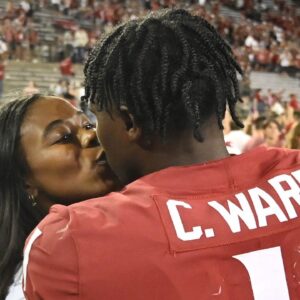 Washington State Cougars quarterback Cameron Ward (1) gets a kiss from his girlfriend Nailah London after a game against the Wisconsin Badgers at Gesa Field at Martin Stadium. Washington State won 31-22.
