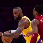 Los Angeles Lakers forward LeBron James (23) moves the ball against Cleveland Cavaliers guard Donovan Mitchell (45) during the first half at Crypto.com Arena