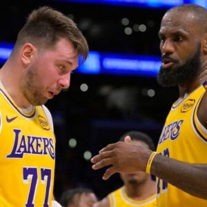 Los Angeles Lakers forward LeBron James (23) checks on guard Luka Doncic (77) after he was hit in the face against the Utah Jazz at Crypto.com Arena