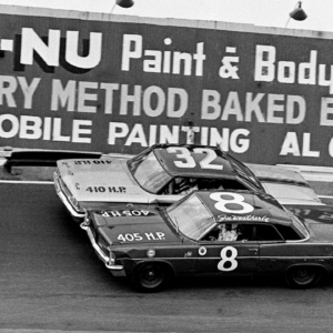 Drivers Joe Weatherly (8) and Tiny Lund (32) battle for position in the Nashville 400 at the Fairgrounds Speedway Aug. 4, 1963. Weatherly went on to place third, while Lund was 16th after getting knocked out with a fiery crash in the rain-shortened NASCAR late model race before 12,875 fans. Auto Racing In 1963
