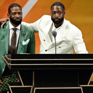 Dwyane Wade (right) calls his father Dwyane Wade Sr. (left) onto the stage at his induction into the 2023 Basketball Hall of Fame at Symphony Hall.