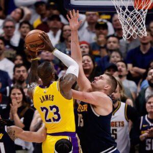 Los Angeles Lakers forward LeBron James (23) drives to the net against Denver Nuggets center Nikola Jokic (15) in the fourth quarter during game five of the first round for the 2024 NBA playoffs at Ball Arena.