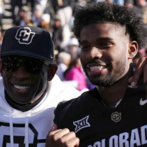 Nov 29, 2024; Boulder, Colorado, USA; Colorado Buffaloes safety Shilo Sanders (21) and head coach Deion Sanders and quarterback Shedeur Sanders (2) and social media producer Deion Sanders Jr. following the win against the Oklahoma State Cowboys at Folsom Field.