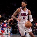 Philadelphia 76ers forward Paul George (8) brings the ball up court against Brooklyn Nets forward Jalen Wilson (22) during the fourth quarter at Barclays Center.