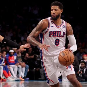 Philadelphia 76ers forward Paul George (8) brings the ball up court against Brooklyn Nets forward Jalen Wilson (22) during the fourth quarter at Barclays Center.