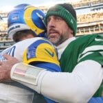 Dec 22, 2024; East Rutherford, New Jersey, USA; Los Angeles Rams quarterback Matthew Stafford (9) hits New York Jets quarterback Aaron Rodgers (8) after the game at MetLife Stadium.