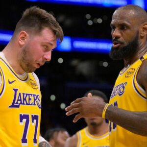 Los Angeles Lakers forward LeBron James (23) checks on guard Luka Doncic (77) after he was hit in the face against the Utah Jazz at Crypto.com Arena