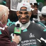 Feb 9, 2025; New Orleans, LA, USA; Philadelphia Eagles quarterback Jalen Hurts (1) talks with Fox announcer Terry Bradshaw after defeating the Kansas City Chiefs in Super Bowl LIX at Ceasars Superdome.