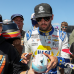 Aug 19, 2023; Watkins Glen, New York, USA; NASCAR Cup Series driver Chase Elliott signs autographs for fans during practice and qualifying for the Go Bowling at The Glen at Watkins Glen International. Mandatory Credit: Matthew O'Haren-Imagn Images