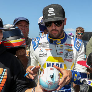 Aug 19, 2023; Watkins Glen, New York, USA; NASCAR Cup Series driver Chase Elliott signs autographs for fans during practice and qualifying for the Go Bowling at The Glen at Watkins Glen International. Mandatory Credit: Matthew O'Haren-Imagn Images
