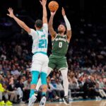 Milwaukee Bucks guard Damian Lillard (0) shoots the jumper over Charlotte Hornets guard KJ Simpson (25) during the second quarter at Spectrum Center.