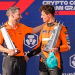 McLaren team principal Andrea Stella and McLaren driver Lando Norris of the United Kingdom hold their trophies as they celebrate on the podium