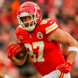 Jan 18, 2025; Kansas City, Missouri, USA; Kansas City Chiefs tight end Travis Kelce (87) runs with the ball during the first half against Houston Texans in a 2025 AFC divisional round game at GEHA Field at Arrowhead Stadium.
