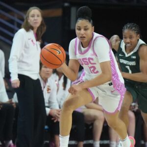 Southern California Trojans guard JuJu Watkins (12) dribbles the ball against Michigan State Spartans guard Jaddan Simmons (1) in the first half at Galen Center