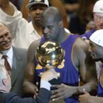 NBA commissioner David Stern hands Los Angeles Lakers Phil Jackson (left), Shaquille O'Neal (center) and Kobe Bryant (right) their championship trophy at the end of Game 4 of the NBA Finals at The Meadowlands.