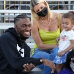 Robert Grifffin III poses with wife Grete Griffin aka Grete Sadeiko and daughter during the Salute to Service Wheelchair Football League Championship Game at the Los Angeles Memorial Coliseum.