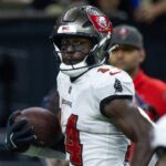 Oct 13, 2024; New Orleans, Louisiana, USA; Tampa Bay Buccaneers wide receiver Chris Godwin (14) looks back at wide receiver Sterling Shepard (17) as he runs in for a touchdown against the New Orleans Saints during the second half at Caesars Superdome.