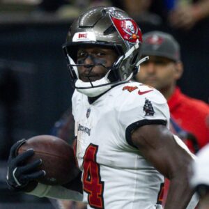 Oct 13, 2024; New Orleans, Louisiana, USA; Tampa Bay Buccaneers wide receiver Chris Godwin (14) looks back at wide receiver Sterling Shepard (17) as he runs in for a touchdown against the New Orleans Saints during the second half at Caesars Superdome.