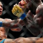 Alex Pereira (red gloves) fights Khalil Rountree Jr. (blue gloves) in a light heavyweight title bout during UFC 307 at Delta Center.