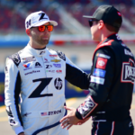 Mar 8, 2025; Avondale, AZ, USA; NASCAR Cup Series driver William Byron (24) meets with driver Christopher Bell (20) during qualifying for the Shrines Children’s 500 at Phoenix Raceway. Mandatory Credit: Gary A. Vasquez-Imagn Images