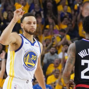 Golden State Warriors guard Stephen Curry (30) celebrates against LA Clippers guard Lou Williams (23) during the first quarter in game one of the first round of the 2019 NBA Playoffs at Oracle Arena.